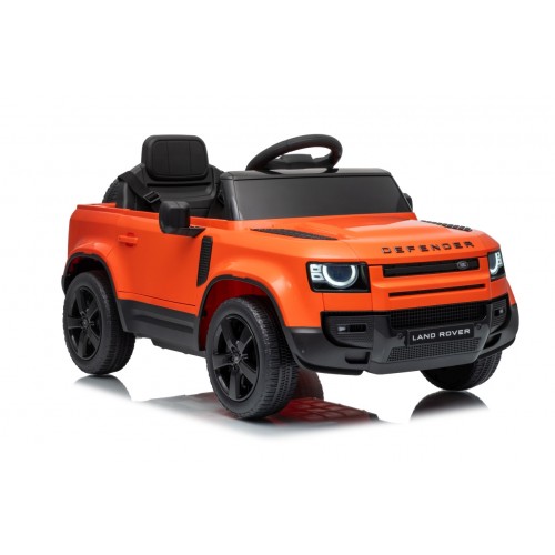 Oranžové vozidlo Land Rover Defender