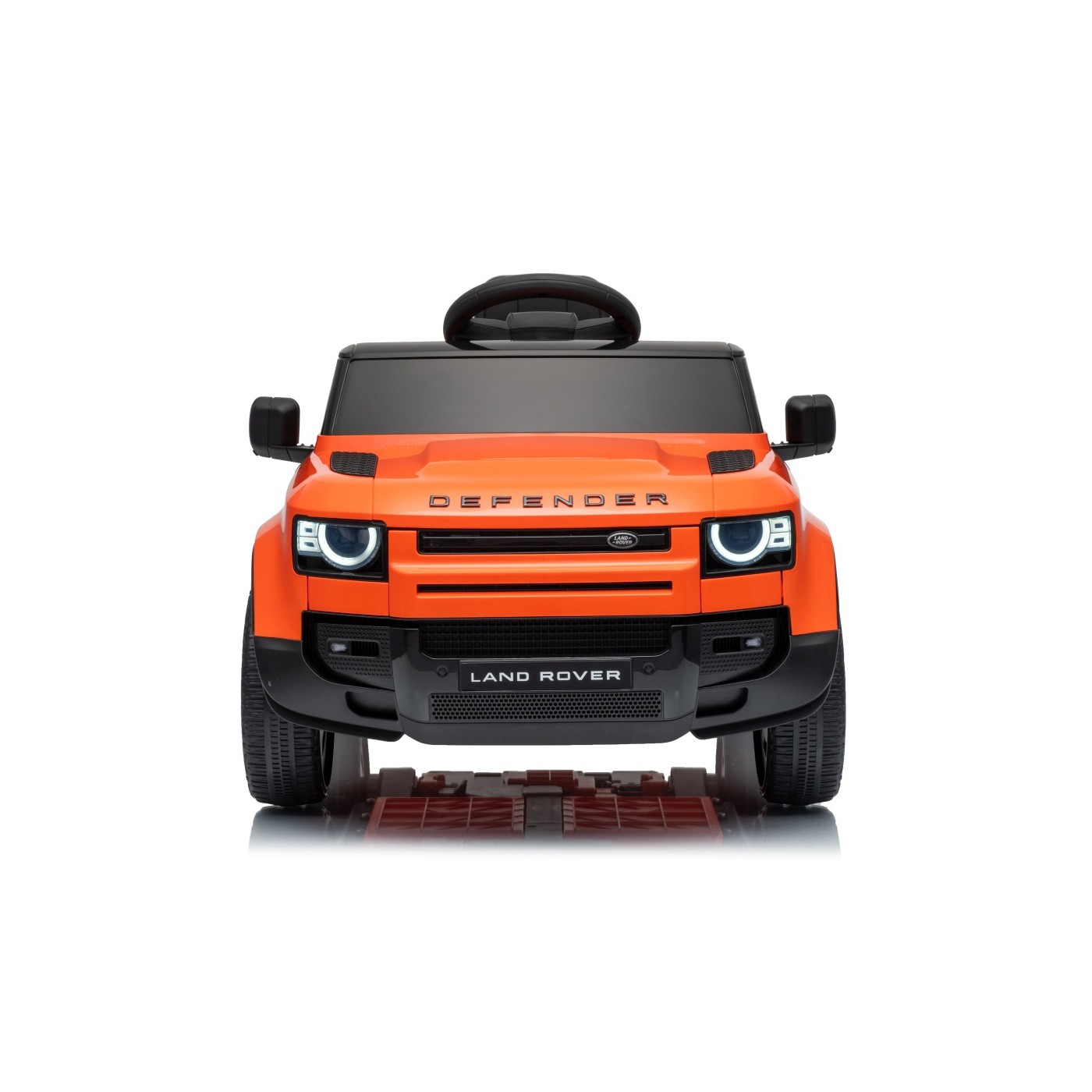 Oranžové vozidlo Land Rover Defender