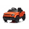 Oranžové vozidlo Land Rover Defender