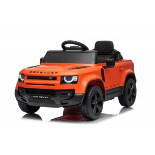 Oranžové vozidlo Land Rover Defender